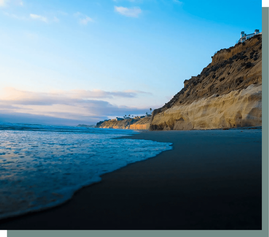 Ocean waves beside a rocky cliff